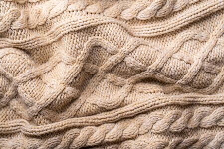 Beige Knitwear Fabric Texture with Pigtails. Beige Knitted Background.