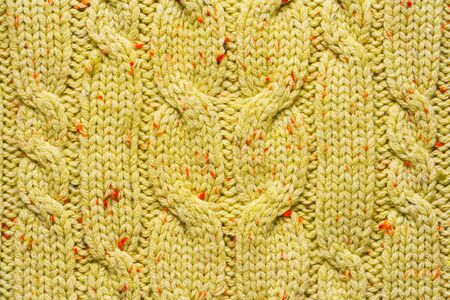 Texture of Wool Knit Color of Mustard Fabric Interspersed with Red Orange Yarn. Sweater Background...