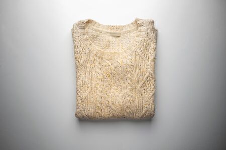 Beige sweater on white view from aboveの写真素材