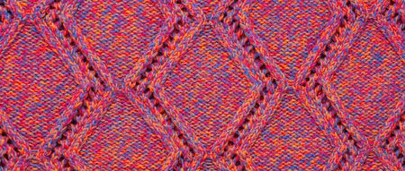 Knitted sweater texture. Pink melange rhombus pattern. Background. Banner. Copy spaceの写真素材