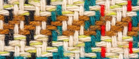 Brown checkered fabric with colored threads. Scottish wool. Fabric for plaid coat and suit....