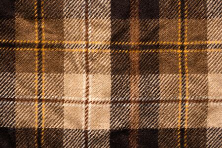 Brown checked fabric. Scottish wool. Fabric for coat plaid suit. Close-up. Backgroundの写真素材