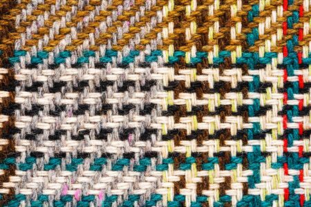 Brown checkered fabric with colored threads. Scottish wool. Fabric for plaid coat and suit....