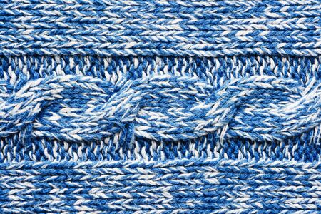 The texture of a knitted blue white sweater. Beautiful textured arana patterns. Background. Copy...