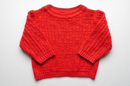 Kids knitted sweater with pattern. Beautiful red woolen autumn sweater with long sleeves. Front view. On white backgroundの写真素材