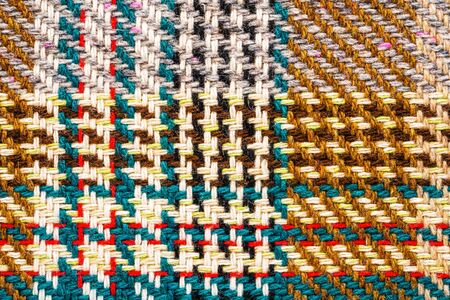 Brown checkered fabric with colored threads. Scottish wool. Fabric for plaid coat and suit....