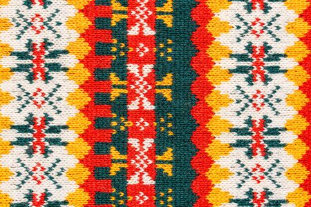 Motley christmas sweater texture with patterns. Colorful knit texture