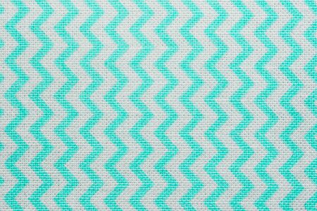Pattern of blue and white striped zig zag. Macro textile texture