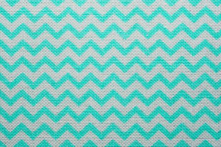 Pattern of blue and white striped zig zag. Macro textile texture