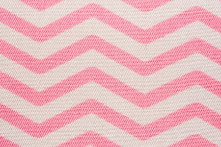 Pattern of pink and white striped zig zag. Macro textile textureの写真素材