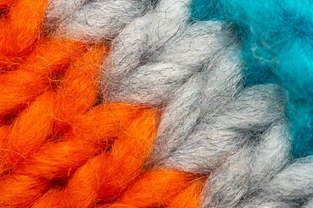 Colorful knit sweater texture macro. Empty copy space background with saturated sweater. Hobby backgroundの写真素材