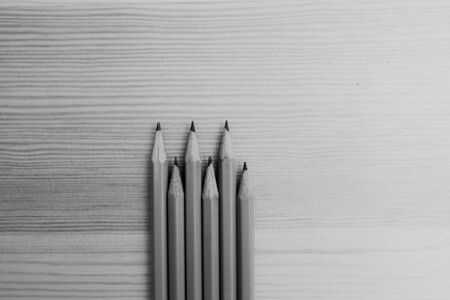 black and white photo of pencils on wooden backgroundの写真素材