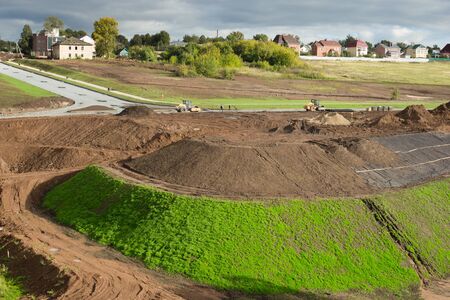 View to the construction of the road type. The high mounds of ground, clay, stones.