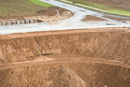 View to the construction of the road type. The high mounds of ground, clay, stones.の写真素材