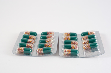 Different medicines. Tablets, pills in blister pack. Medications drugs. Pills over a white...