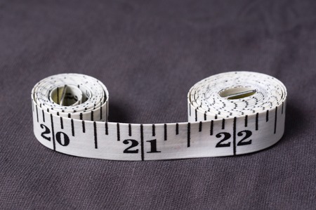 Inch, centimeter tape tailor folded in the form of eight