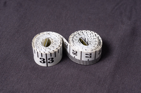 Inch, centimeter tape tailor folded in the form of eight