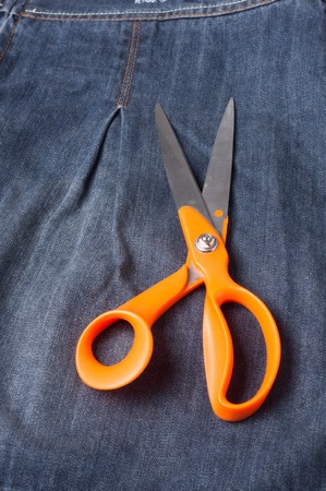 Jeans close-up, seams,  scissors. Interlacing the fabric with a close-upの写真素材