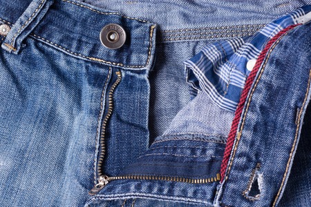 Jeans close-up. Clasps, seams, zippers. Interlacing the fabric with a close-upの写真素材