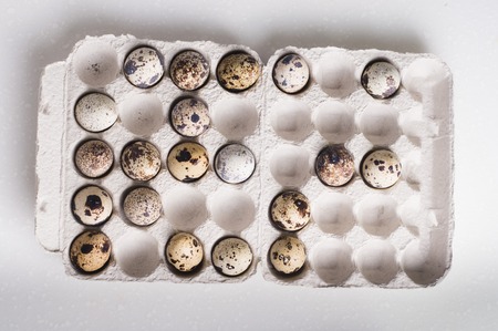 Quail eggs in cardboard packaging in random order.
Vegetarian organic  eco food.の写真素材