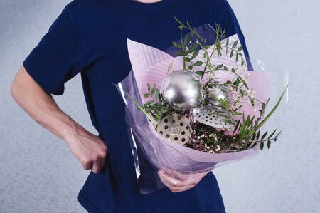 A man gives a bouquet of flowers and ladles. concept of patriarchal society and gender inequality.の写真素材