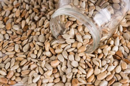sunflower seeds in a jar  on white wooden background. vegetarian food, eco food conceptsの写真素材