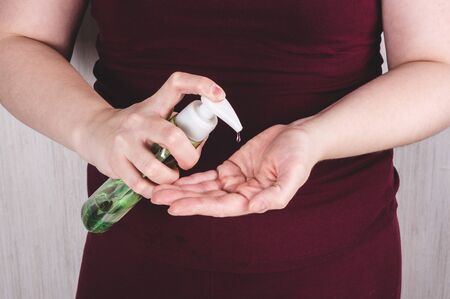 Cleaning hands with sanitizer gel. Preventive gearin quarantine for coronavirusの写真素材