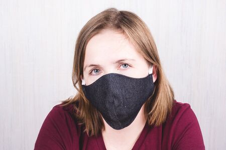 Woman wearing protection handmade face mask against coronavirus. Ð¡oronavirus preventive gearの写真素材