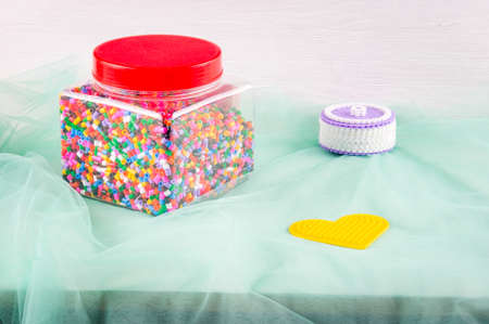 Thermomosaic beads in jar, heart-shaped form and homemade plastic jewelry box.