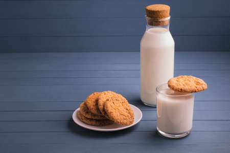 Fresh baked butter cookies with milk. Homemade oven cookies on a blue wooden background.の写真素材