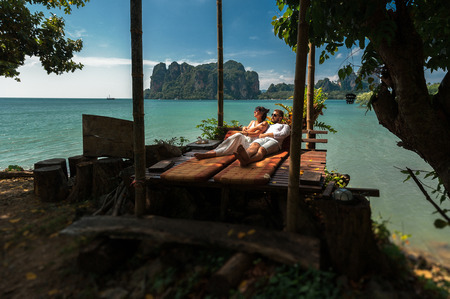 Couple in love off the coast. Couple by the sea. A guy and a girl travel to beautiful places. Couple in love at the lagoon. Honeymoon trip. Relax on the island. Travel to Asiaの写真素材
