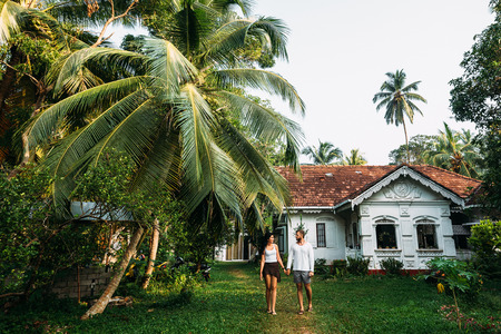 The couple in the home garden. A guy and a girl rent a house. A couple in love travels. Man and woman in Asia. Loving couple Newly married coupleの写真素材