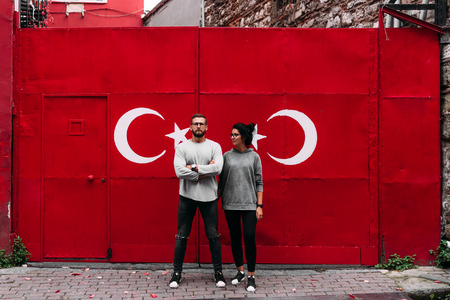 Selfie guy and girl. Couple in Turkey. Couple on the background Guy and girl traveling. Man and woman. Turkish flag. Couple on a background of graffiti. Graffiti on the wallの写真素材