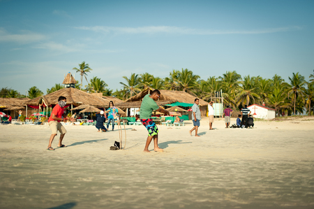 Friends play cricket on the beach of GOA in India. The guys play Indian baseball on the beach. Indian national sport. The game of cricket at sunsetのeditorial素材