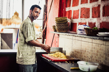 Indian street cook preparing food. Street food. Chef at beach cafes in Goa. Cooking unsanitary conditions. Street kitchen. Indian chefのeditorial素材