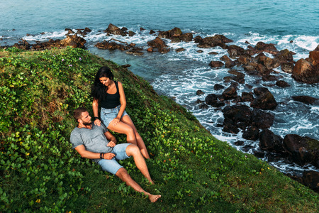 Couple on the shore of the sea meets the dawn.の写真素材