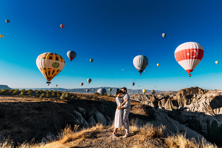 Wedding travel. Honeymoon trip. Couple in love among balloons in Cappadocia.の写真素材