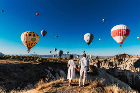 Wedding travel. Honeymoon trip. Couple in love among balloons in Cappadocia.の写真素材