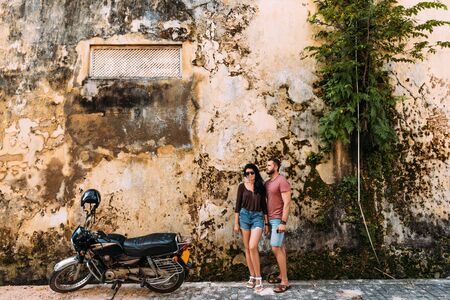 The couple travels on a scooter in Sri Lanka. Man and woman traveling. The couple travels to Asia....
