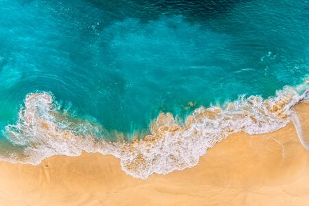 Aerial view of turquoise ocean waves in Kelinking beach, Nusa penida Island in Bali, Indonesia....