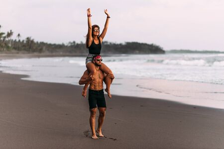 Happy couple on vacation. Lovers on the coast. Man and woman are resting on the sea. Beautiful couple have fun at the sea. Vacation at sea. Vacation on the island of Bali. Travel to Asiaの写真素材