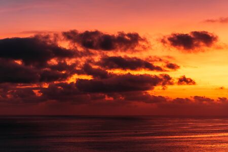 Beautiful clouds at sunset in the sea. Beautiful sunset on the sea in Asia. Warm sun. Landscapes of Bali Indonesiaの写真素材