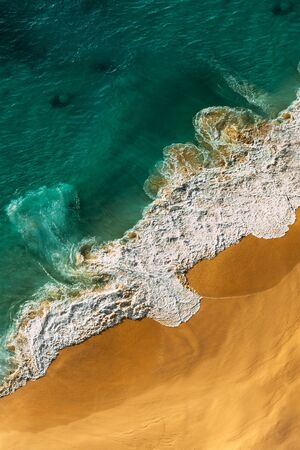 Beautiful sandy beach with turquoise ocean, vertical view. Drone view of tropical turquoise ocean beach Nusa penida Indonesia. Lonely sandy beach with beautiful waves. Beaches of Indonesia. Copy spaceの写真素材