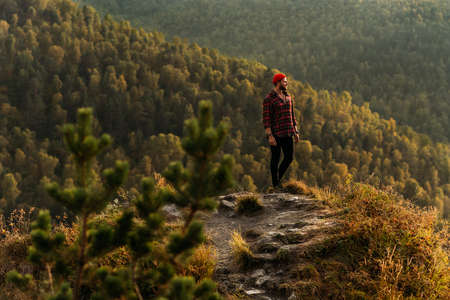 Traveler in the mountains. A man enjoys a beautiful view of the mountains. Man at sunrise in the...