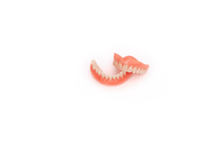 Full removable plastic denture of the jaws. Set of dentures on a white background. Two acrylic...