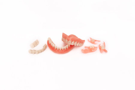 Dentures on a white background. Close-up of dentures. Full removable plastic denture of the jaws....
