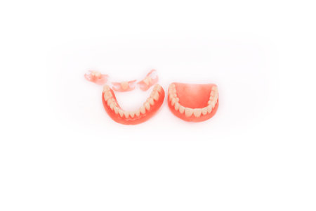 Dentures on a white background. Close-up of dentures. Full removable plastic denture of the jaws....