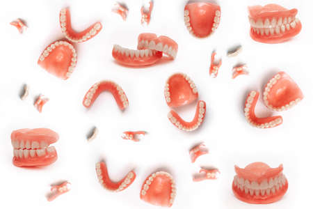Set of dentures on a white background. Full removable plastic denture of the jaws. Isolate on white...