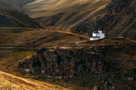 White house among the mountains. Beautiful autumn landscape. Small house in the mountains. Beautiful mountain landscape, autumn. Autumn mountains. Copy spaceの写真素材