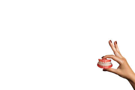 Full removable plastic denture of the jaws. Set of dentures on a white background. Two acrylic...